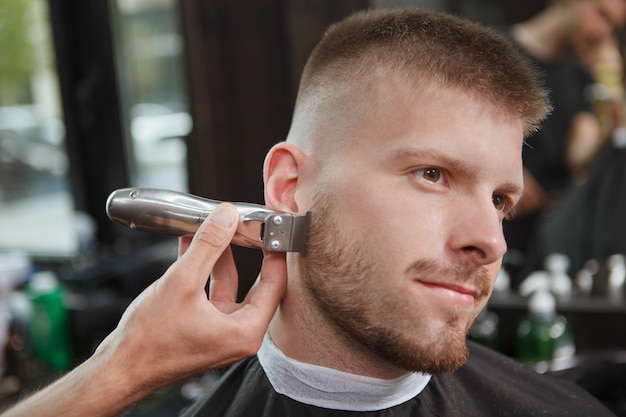 Barber shaving a client at the salon