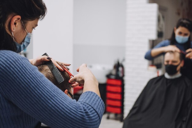 Barber shops hair salons shutting down second lockdown hairdresser in face mask peeling and combing