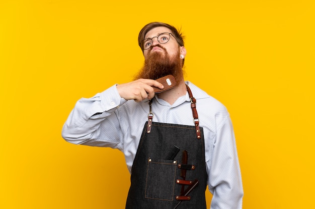 Barber with long beard in an apron 