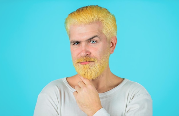 Barbershop concept modern man with bleached hair and beard coloring of mens hair bearded man with