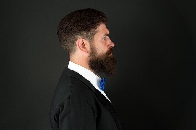 Barbershop concept Stylist fashion expert Suit style Fashion trends for groom Groom bearded hipster man wear tuxedo and bow tie Wedding day Fashion collection Long beard and mustache