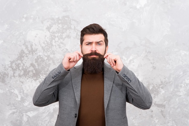 Barbershop service. Elegance stays in fashion. Fashion model touch his moustache. Man wearing autumn jacket. Jacket makes man look more elegant. Business success. get warm and comfortable this season.