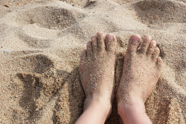 Bare feet in the sand on beach