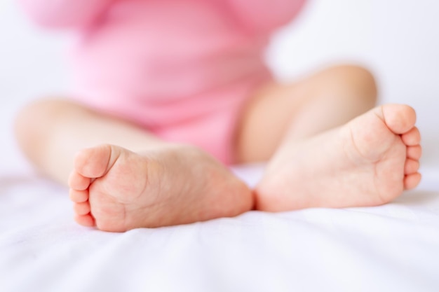 Bare feet of a small healthy baby closeup babys legs