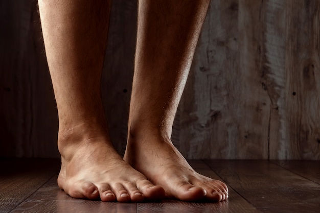 Bare feet on wooden background