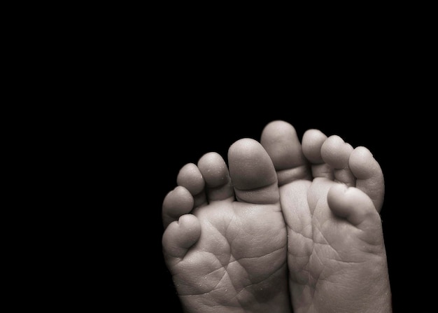 Barefoot against black background