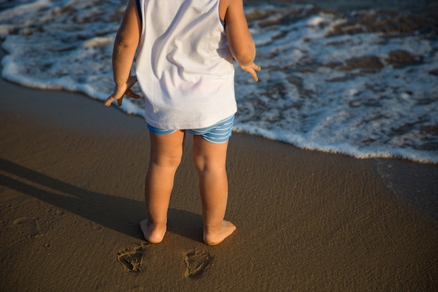 Barefoot child by the sea