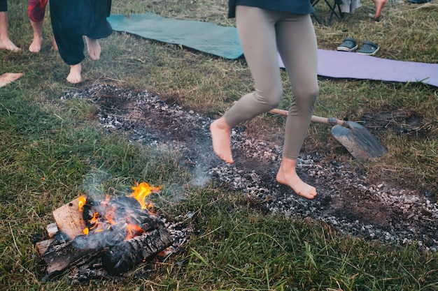 Barefoot person coal walking or fire walking on hot embers
