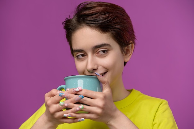 A barely awake pretty brunette enjoys her morning tea or coffee