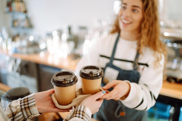 Barista girl holding take away coffee at the cafe shop Takeaway food