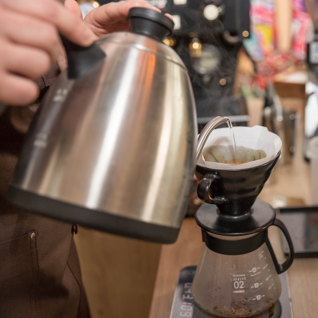 Barista make a filter coffee