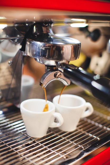 Barista makes coffee in a coffee machine