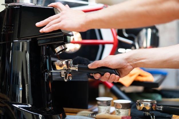 Barista makes coffee in a coffee machine