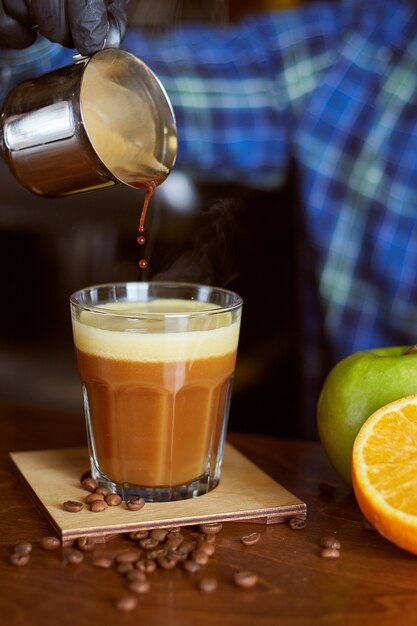 Barista making coffee cocktail. Espresso with Orange & Apple juice