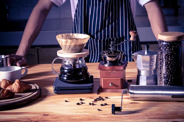 Photo barista making coffee in vintage color coffeeshop drip coffee concept