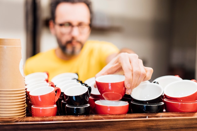 Barista man working in coffee shop.