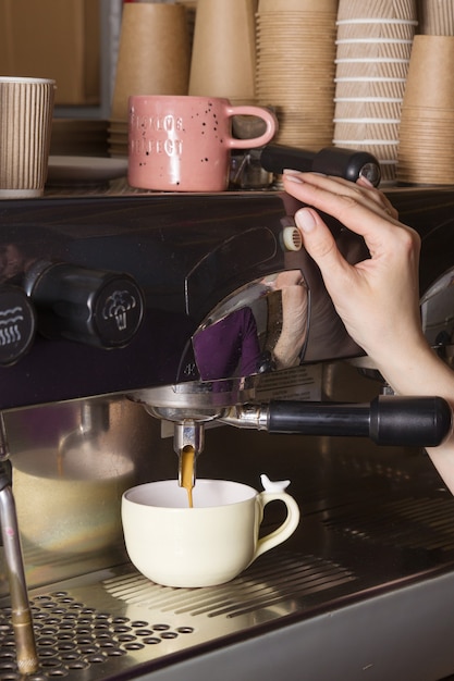 Barista prepares coffee in a small coffee shop