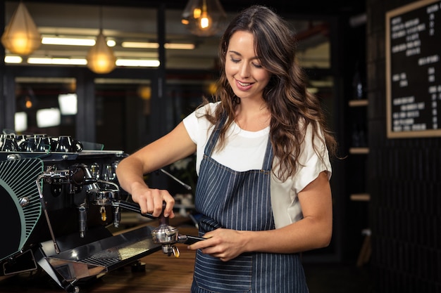 Barista preparing coffee with machine