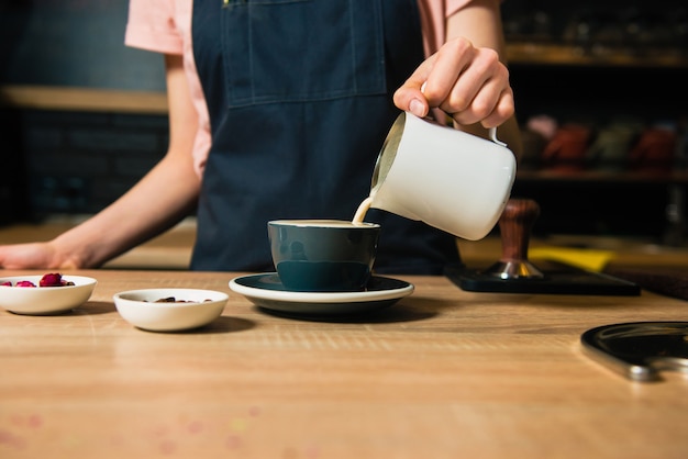 Barista schenkt melk uit de kan