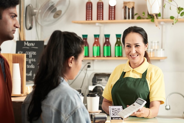 barista showing calculator to customers