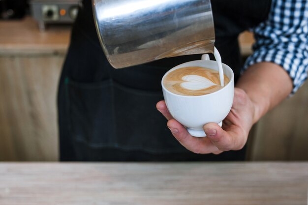 Barista skills pour milk latte cup coffee bar