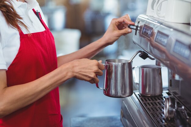 A barista using the coffee machine