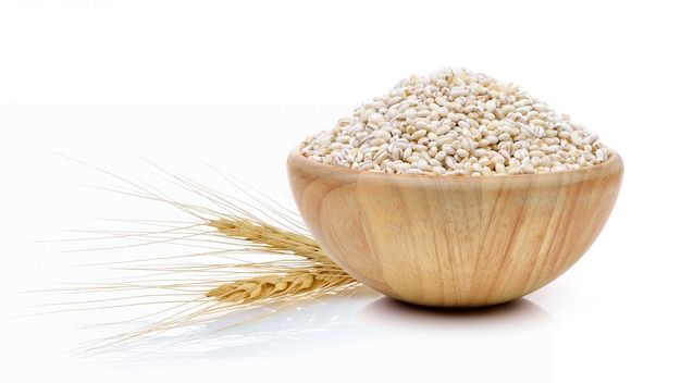 Barley Grains in the wood bowl isolated