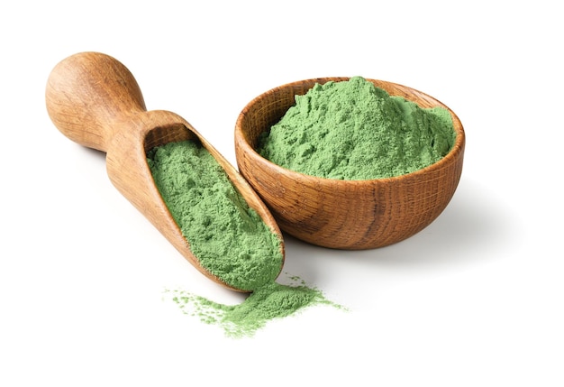 Barley grass powder in wooden bowl with wodden shovel detox superfood