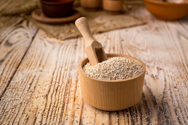 Barley groats in bowl on a wooden background Healthy dietary cereals concept