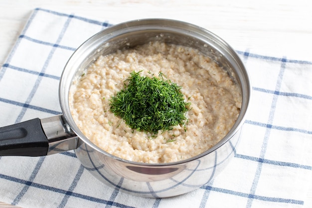 Barley porridge with dill in a saucepan Recipe preparation step by step