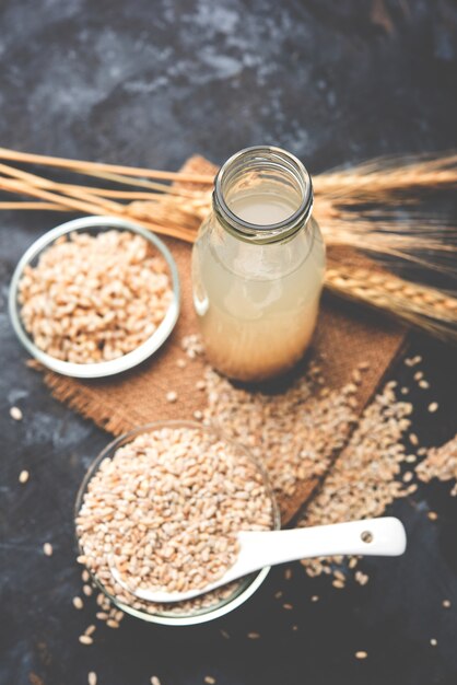 Barley water in glass with raw and cooked pearl barley wheat or seeds. selective focus