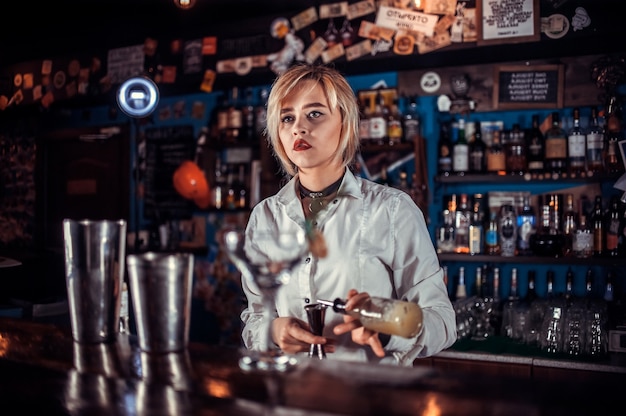 barmaid formulates a cocktail on the taproom