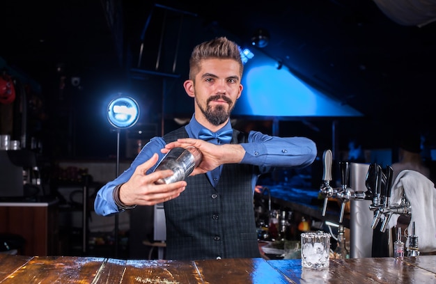 Barman creates a cocktail in the alehouse