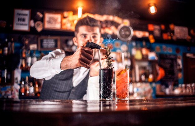 Barman creates a cocktail behind the bar