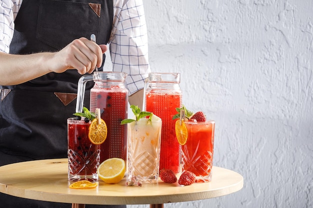 Barmen preparing tea in restaurant Teapots on table in restaurant Barmen's hands