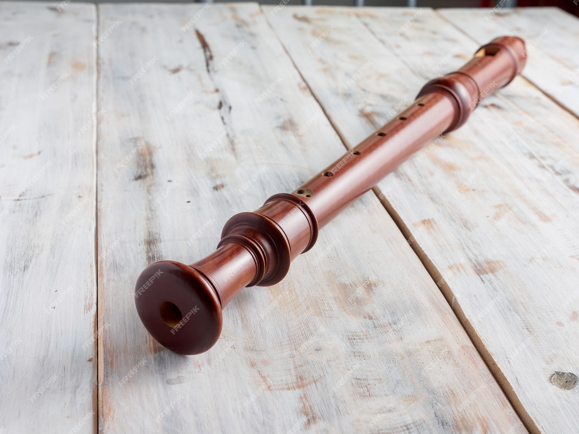 Premium Photo | Baroque recorder or flute isolated on a wooden background,  music instrument