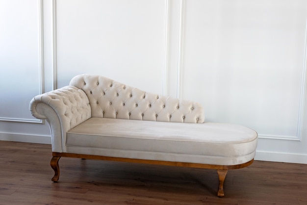 Baroque sofa vintage furniture pastel beige sofa with carriage\
screed restoration of vintage furniture furniture manufacturing\
interior design soft selective focus