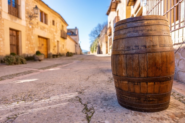 Barrel of ancient wine made of wood in the streets of the medieval village of Pedraza in Castilla y Leon