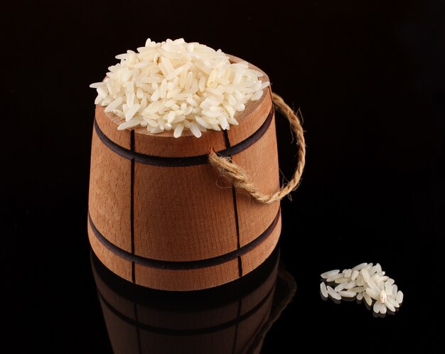 Barrel with rice on black