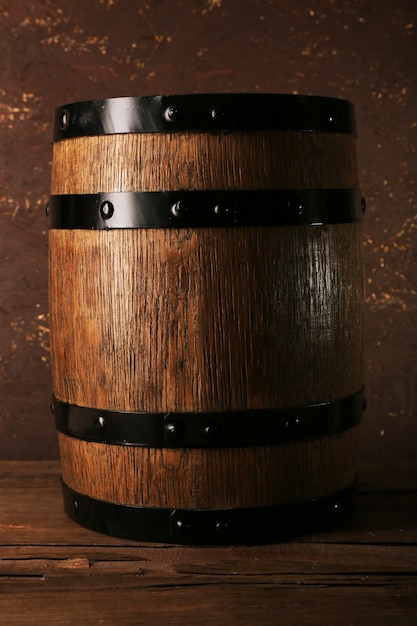 Photo barrel on wooden table on wooden wall background