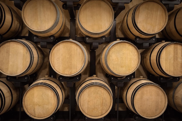 Barrels with red wine in winery vault, wine production background