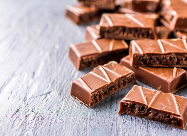 Bars of milk chocolate on a wooden table