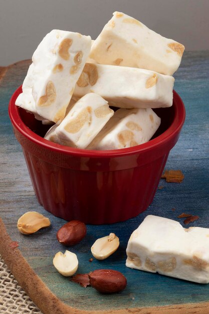 Bars of nougat in a red bowl.