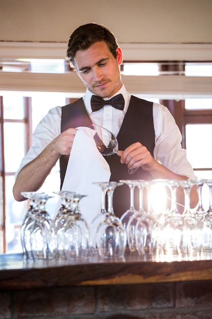 Bartender cleaning wineglass