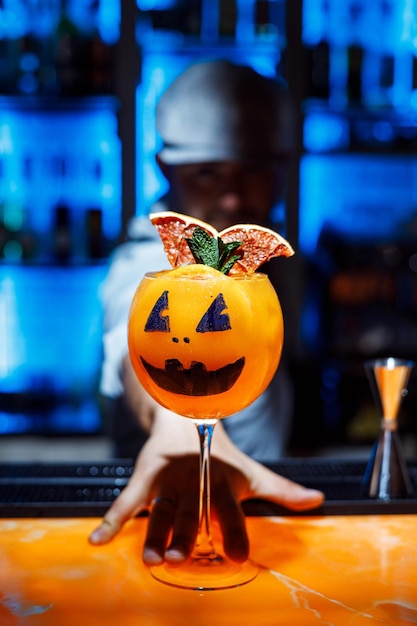 a bartender gives a Halloween cocktail