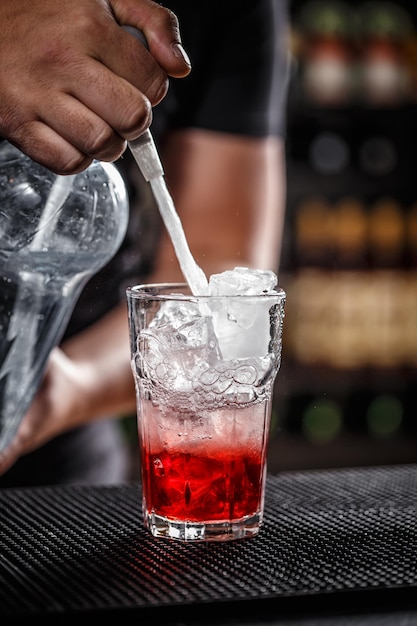 Bartender is pouring soda water