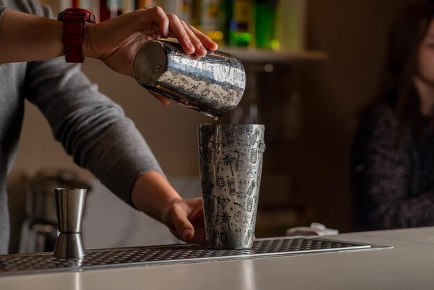 Bartender is preparing a cocktail at the bar