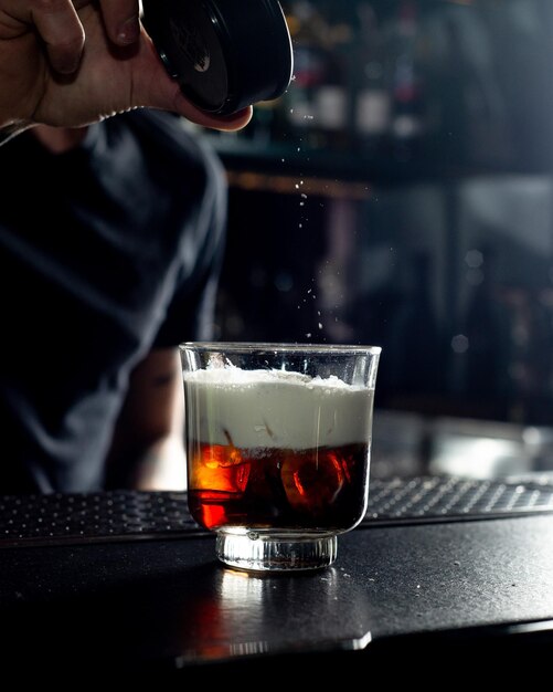 Bartender is preparing a cocktail at the bar