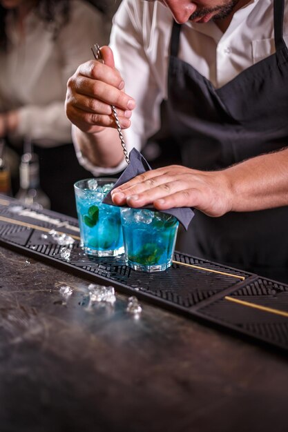 Photo bartender is stirring cocktails