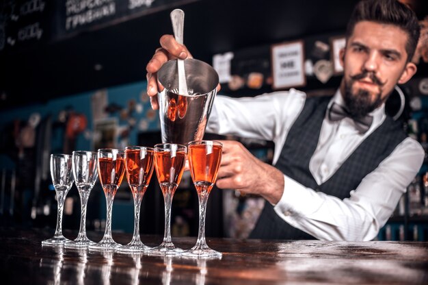 Bartender makes a cocktail at the alehouse